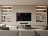 Modern living room with a bespoke media wall, integrated shelves, and television, showcasing an organized and stylish home interior.