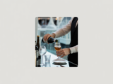 Dedicated bottle service at a VIP table in a luxury nightclub, server pouring a drink.