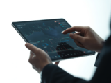 Person evaluating cryptocurrency exchange options on a tablet, symbolizing secure digital finance.