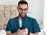 Patient reading online dental clinic reviews on smartphone
