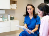 Dentist reviewing customized treatment plan with patient in modern Aspen Dental office
