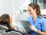Dentist talking to patient