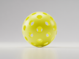 Close-up professional photograph of a 40-hole outdoor pickleball ball on a white background